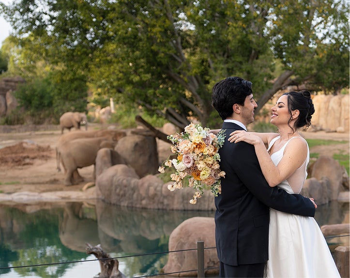 Couple in wedding attire at park