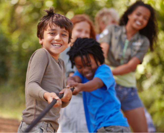 A group of young children tugging a rope